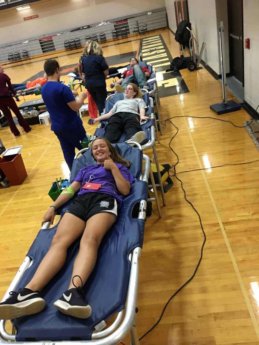 girls on cots with thumbs up